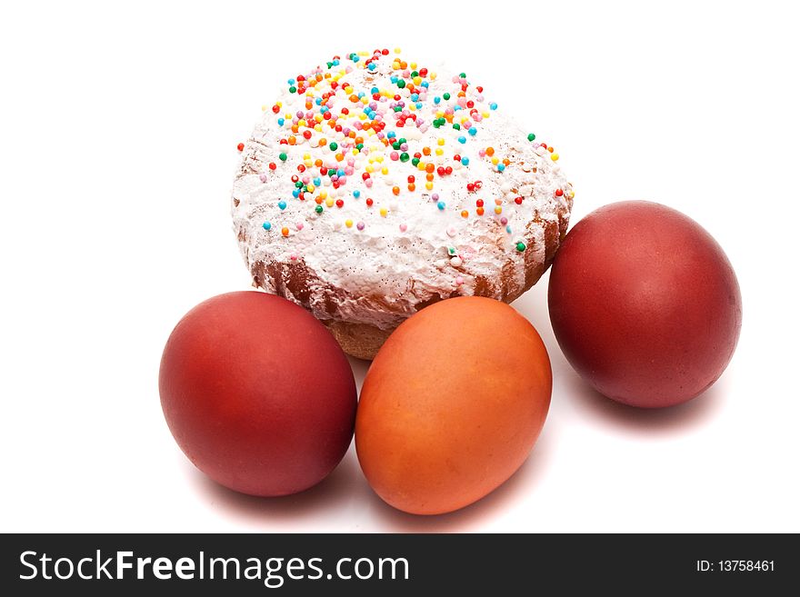 Red Easter eggs and Easter bread on a white background
