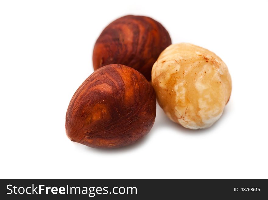 Purified hazelnuts on a white background close