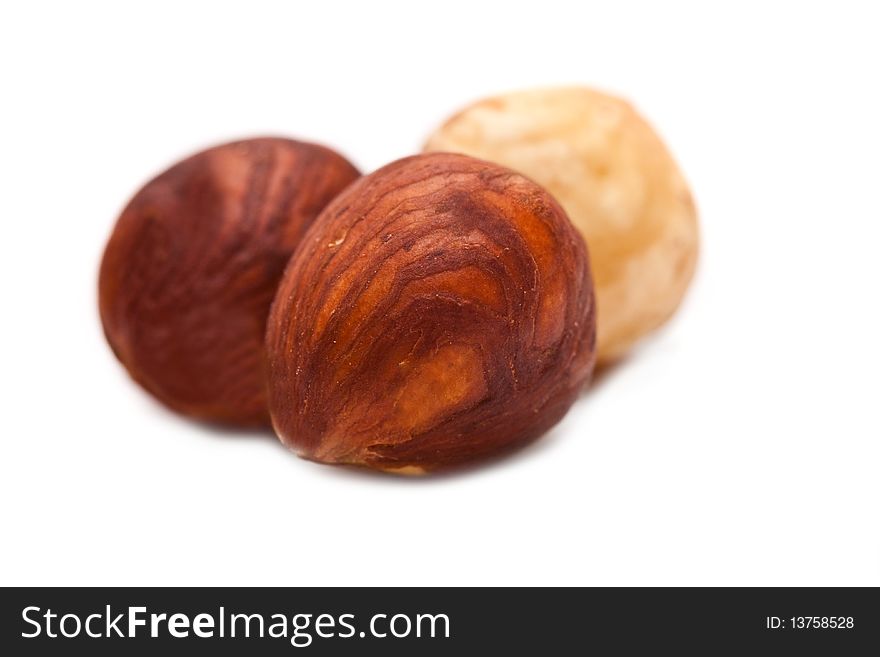 Purified hazelnuts on a white background close