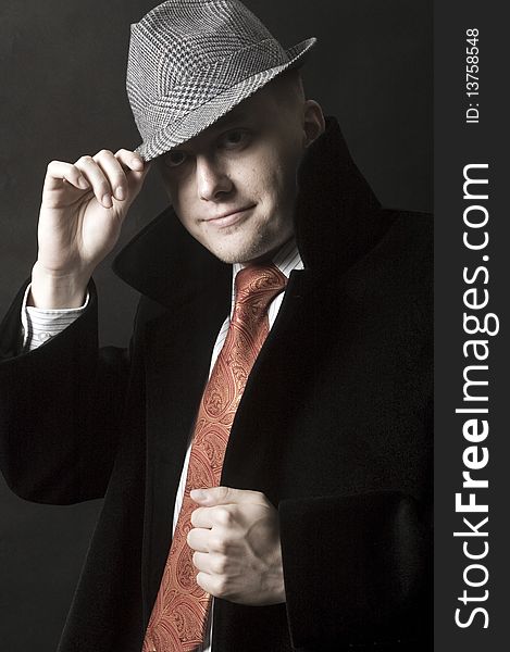 Young European gentleman with elegant clothes, tie and coat, wearing stylish hat. Young European gentleman with elegant clothes, tie and coat, wearing stylish hat.