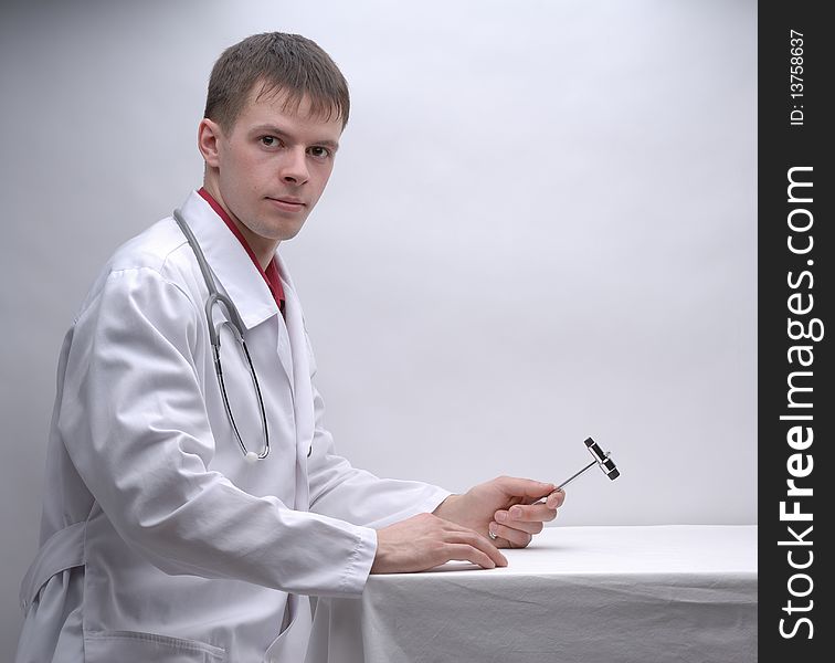 Portrait of young doctor with medical hammer