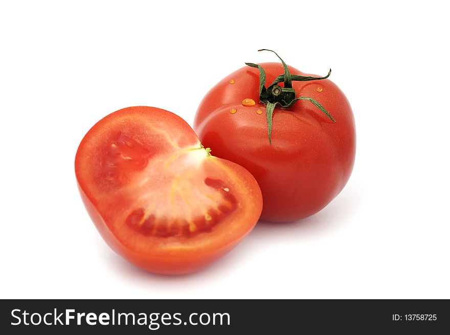 Beautiful ripe tomatoes with water drops isolated on a white background