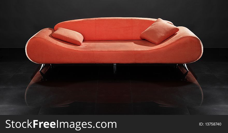 Red sofa against the black background