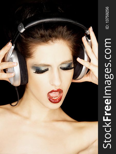 Portrait of a beautiful brunette woman with a headphones