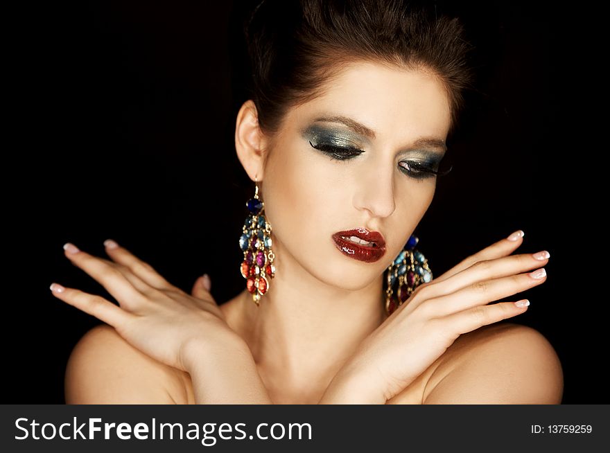 Portrait of a beautiful brunette woman isolated  on black