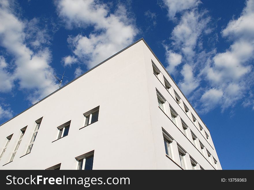 The face of an modern house against a blue sky. The face of an modern house against a blue sky