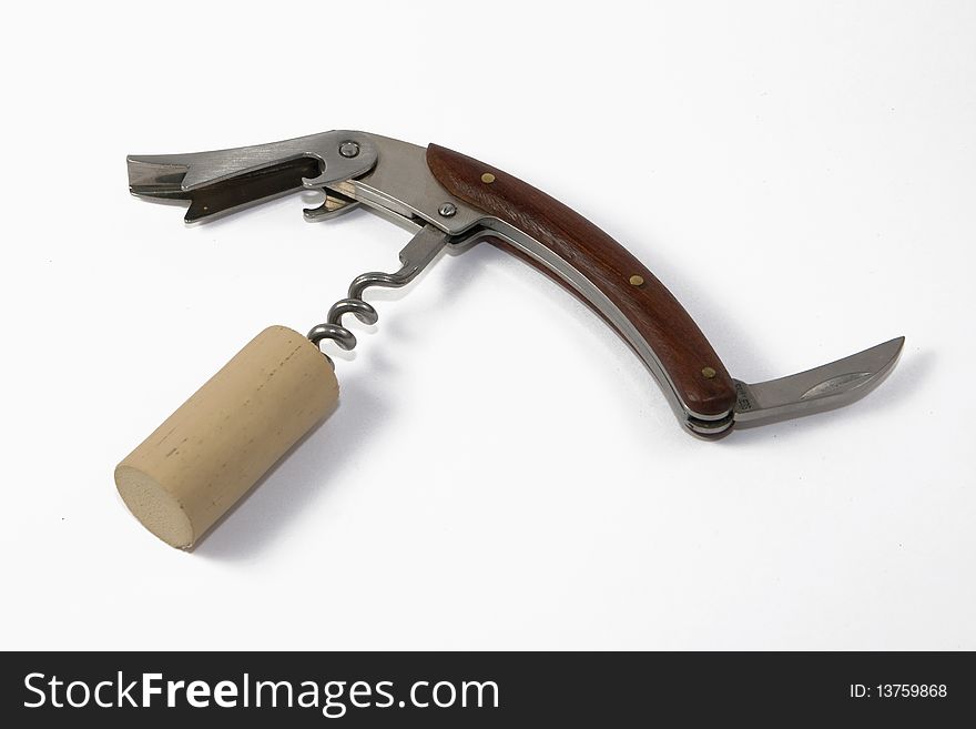 Corkscrew with cork on white background