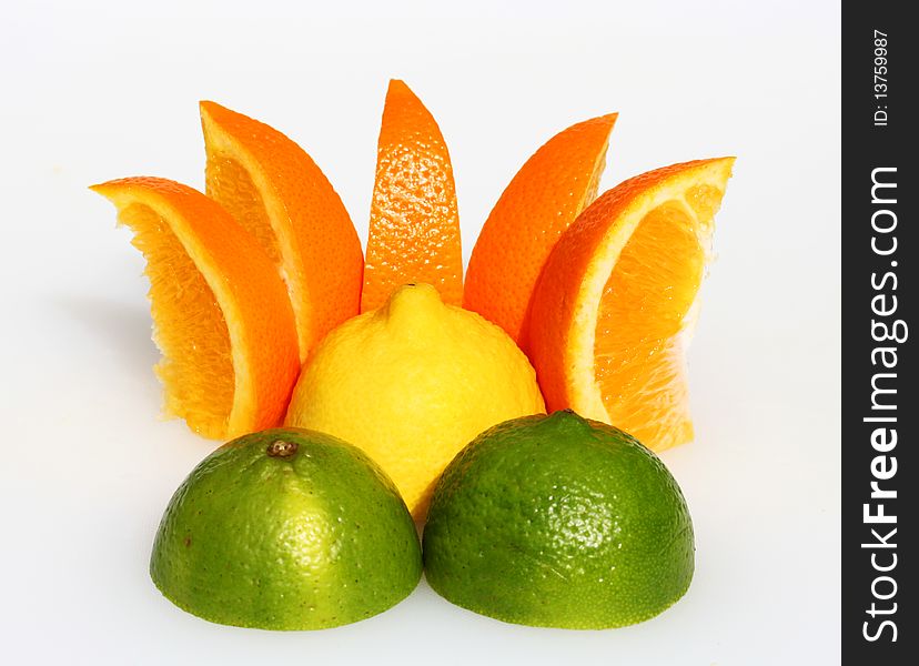 A lemon sunset, with a lemon representing the sun, orange segments as the rays and two cut lime halves as the mountains in the foreground.