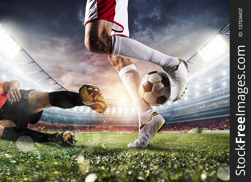 Soccer players with soccerball at the illuminated stadium during the match. Soccer players with soccerball at the illuminated stadium during the match