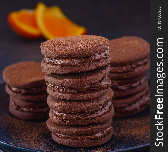 Chocolate cream macaroons or biscuits baked with chocolate orange cream. Chocolate cream macaroons or biscuits baked with chocolate orange cream