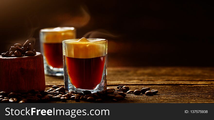 Cappuccino, espresso and coffee beans on old wooden table. Cappuccino, espresso and coffee beans on old wooden table