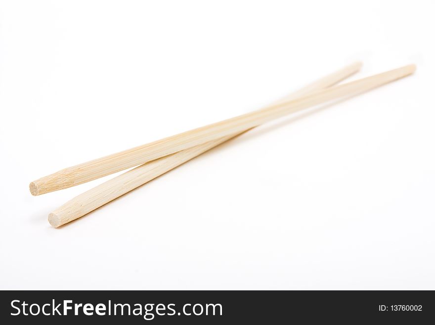 Pair of wood or bamboo Chopsticks isolated against white background.