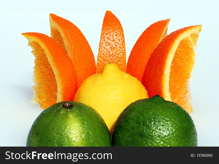 A lemon sunset, with a lemon representing the sun, orange segments as the rays and two cut lime halves as the mountains in the foreground. A lemon sunset, with a lemon representing the sun, orange segments as the rays and two cut lime halves as the mountains in the foreground.