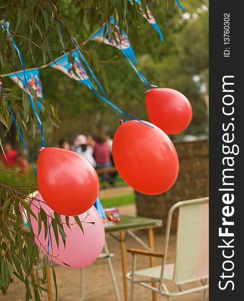 Birthday celebration balloons outdoors with park as backgraund