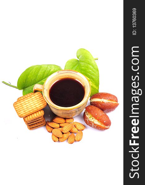 Herbal  tea with biscuits sweets and almonds isolated on white background. Herbal  tea with biscuits sweets and almonds isolated on white background.