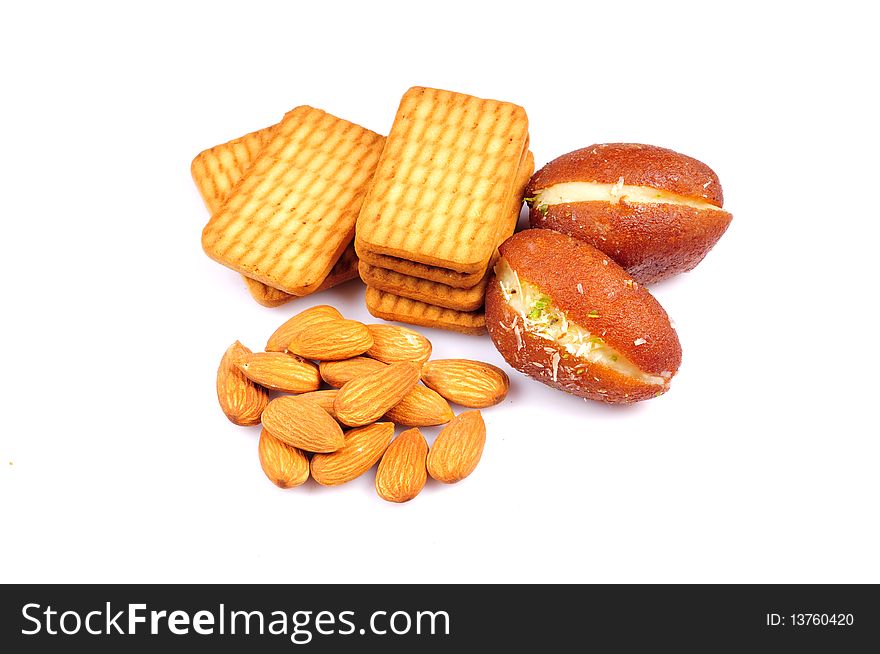 Variety of food products biscuits, almonds and gulab jamun isolated on white background. Variety of food products biscuits, almonds and gulab jamun isolated on white background.