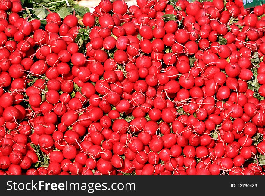 Close-Up Of Radishes On Display In A Produce Market. Close-Up Of Radishes On Display In A Produce Market