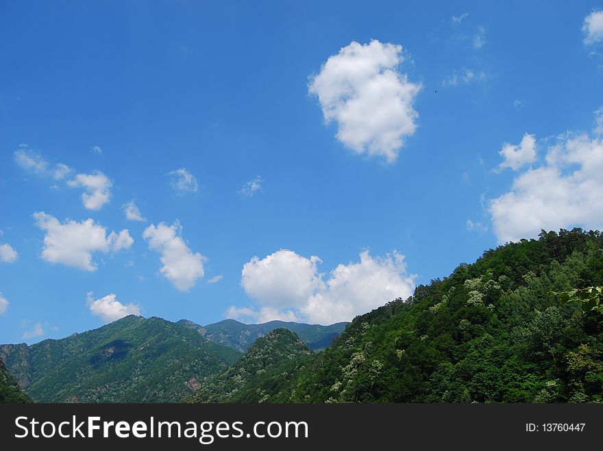 White clouds spread over Romanian mountains. White clouds spread over Romanian mountains.