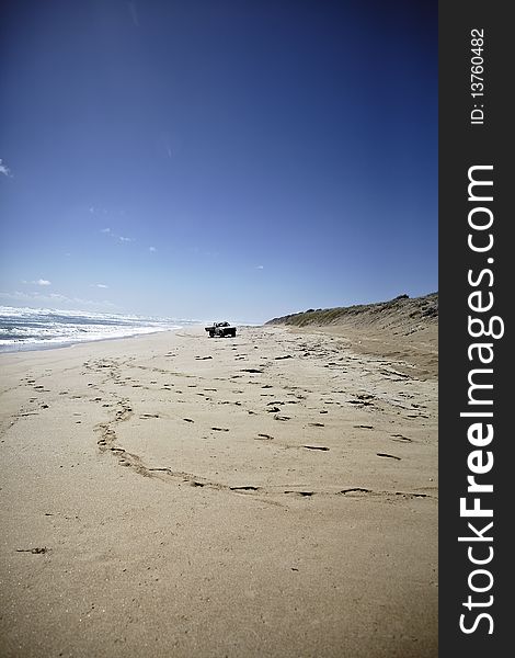 Truck driving on the beach