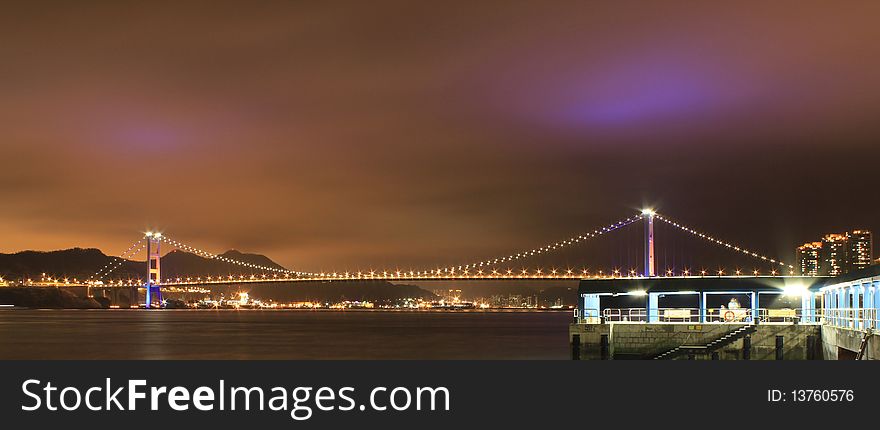 Tsing Ma Bridge night view with a small pier