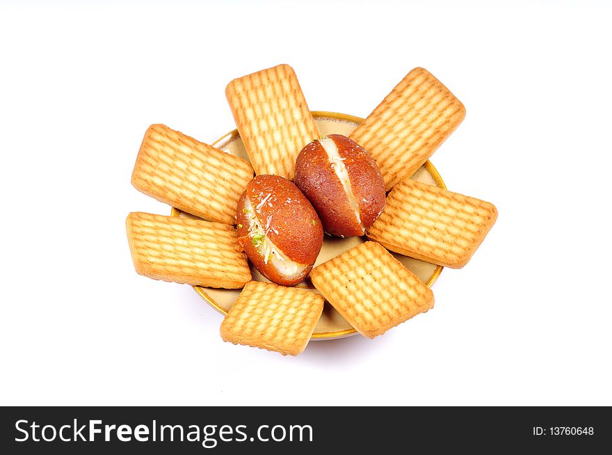 Gulucose biscuits and gulab jamuns isolated on white background. Gulucose biscuits and gulab jamuns isolated on white background.