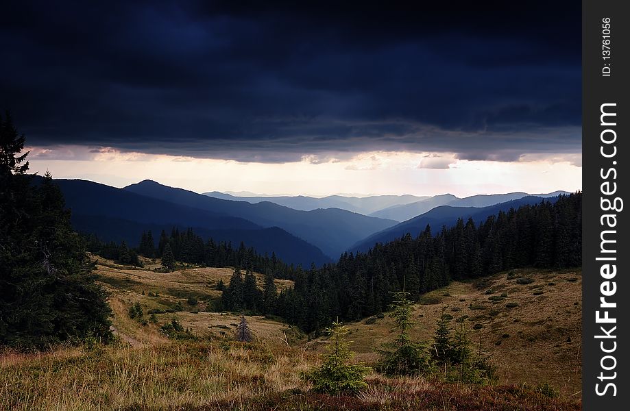 Dense thunderclouds in mountains before a rain. Dense thunderclouds in mountains before a rain