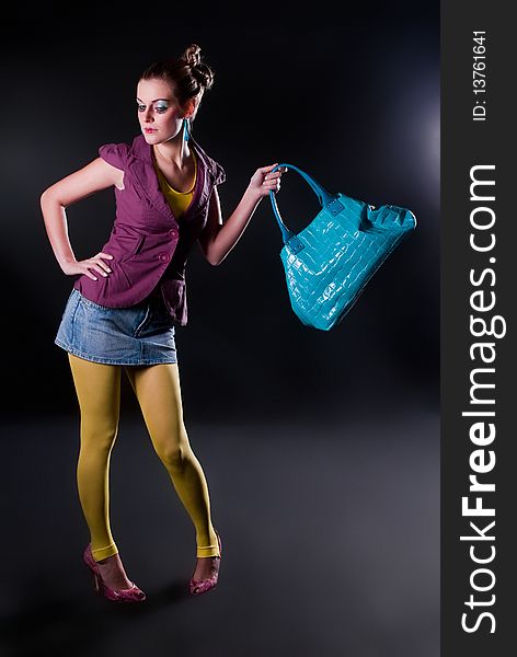 Fashion photo, model with a bag posing on light background. Fashion photo, model with a bag posing on light background