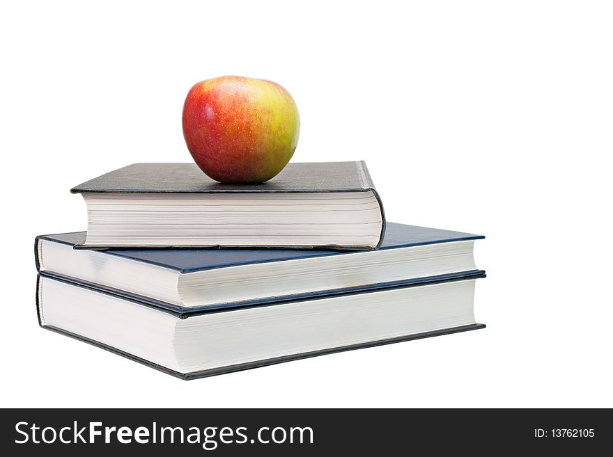 Red-yellow apple and books isolated on a white background. Red-yellow apple and books isolated on a white background.
