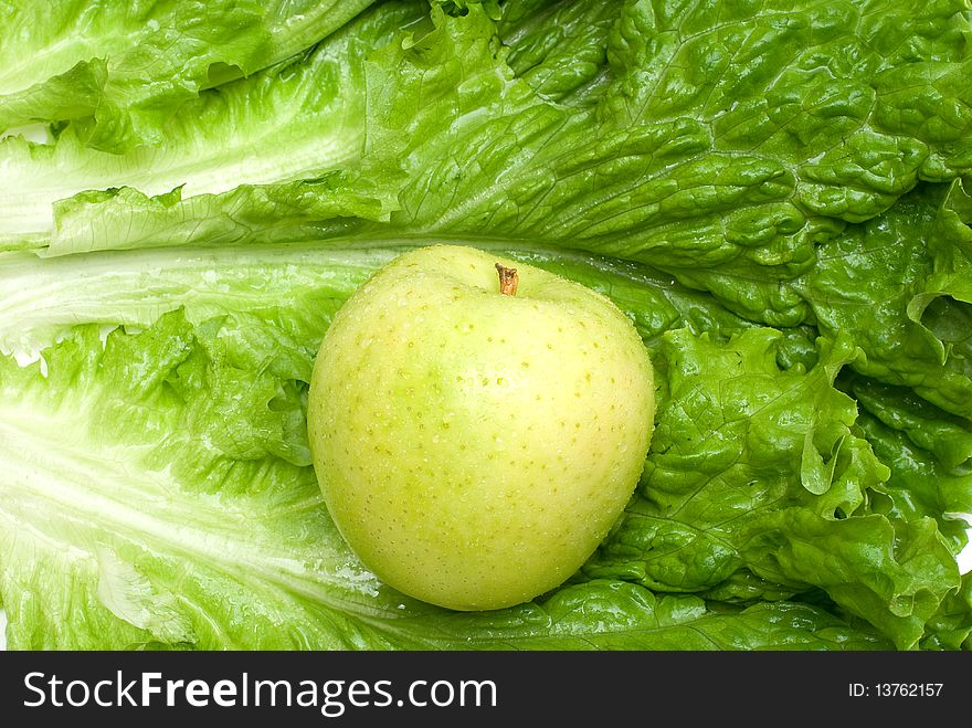 Green apple on the lettuce background. Green apple on the lettuce background