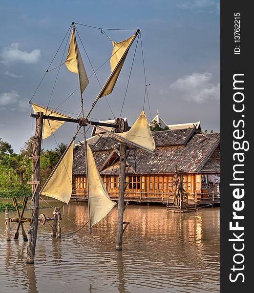 Old wooden windmill in SE asia under the sunset light, HDR image