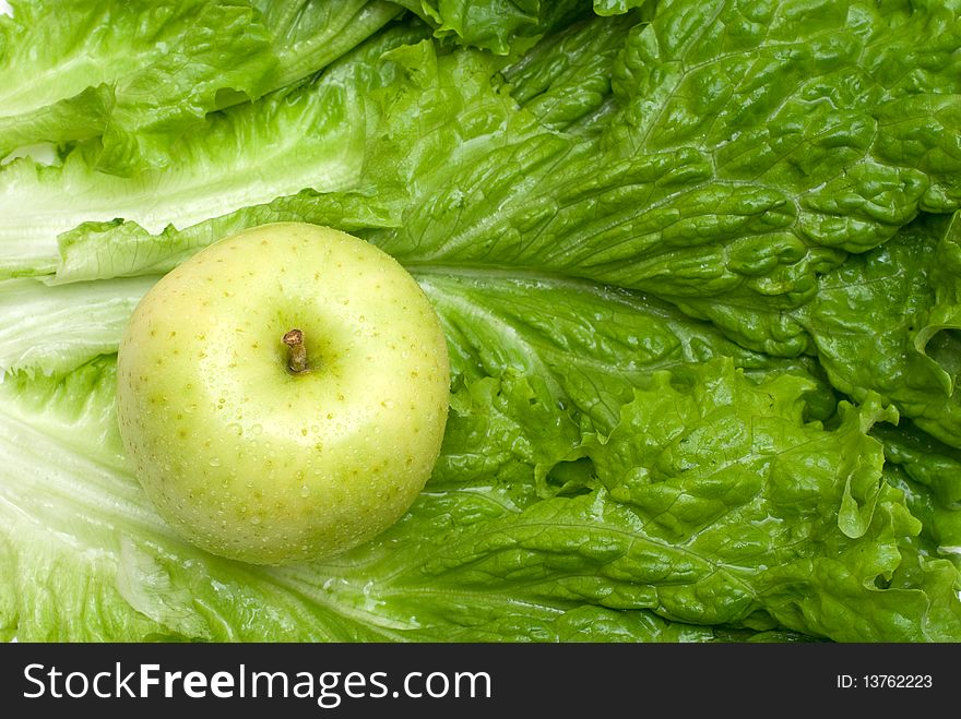 Green apple on the lettuce background. Green apple on the lettuce background