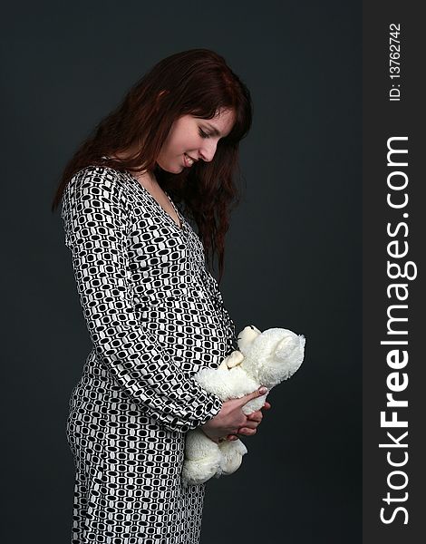 Young pregnant woman isolated on black background