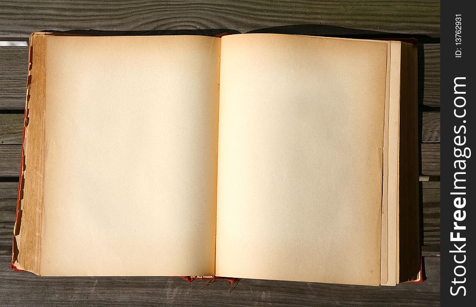 Old book with blank pages on wooden background