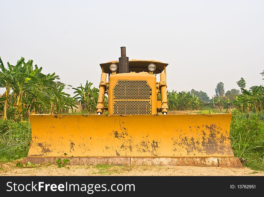 Yellow bulldozer in a farm in Thailand.