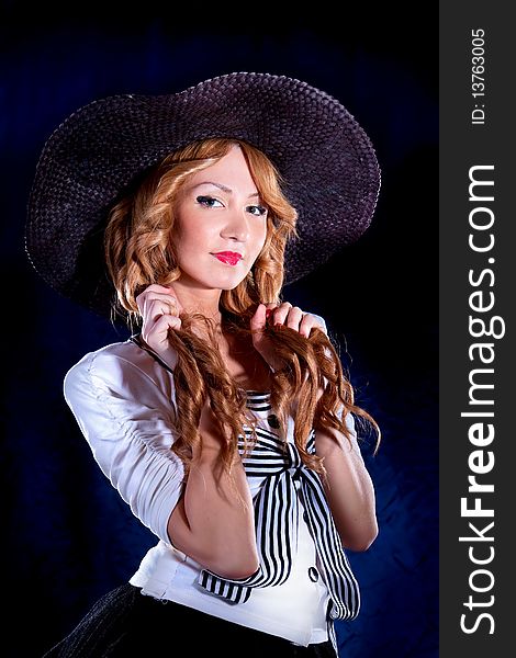 Photo-session of the young beautiful  woman with black hat