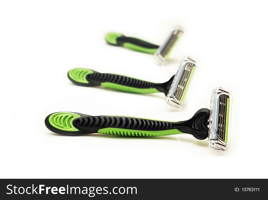 Three black and green razors. Three black and green razors