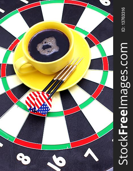 Darts and coffee, in bright cups on a white background