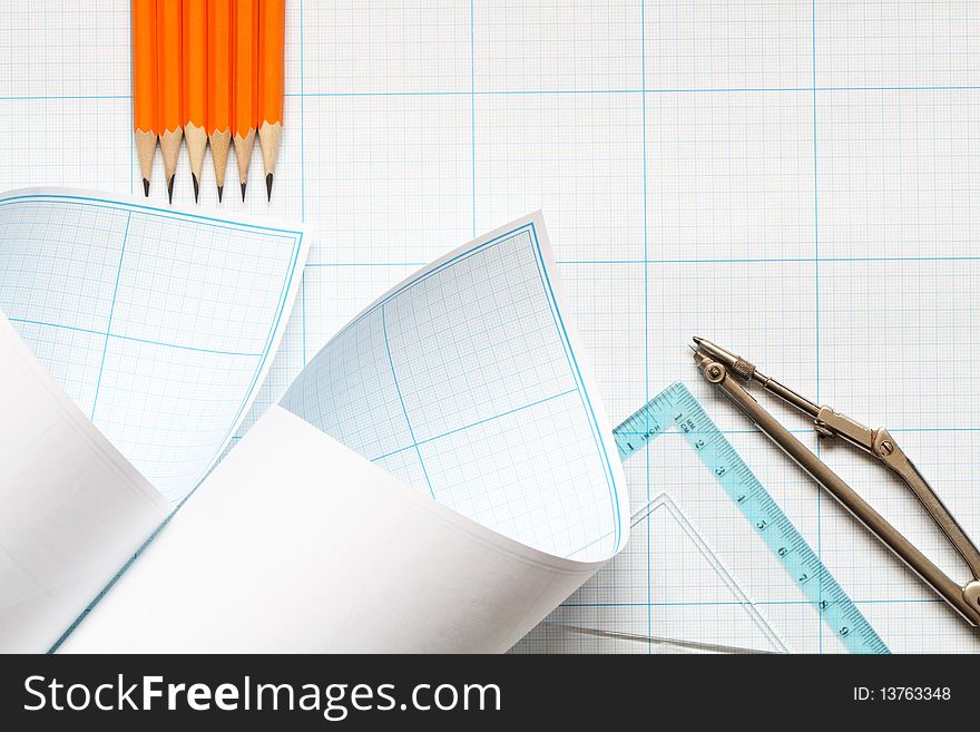 Divider, pencils and ruler on blue graph paper background. Divider, pencils and ruler on blue graph paper background