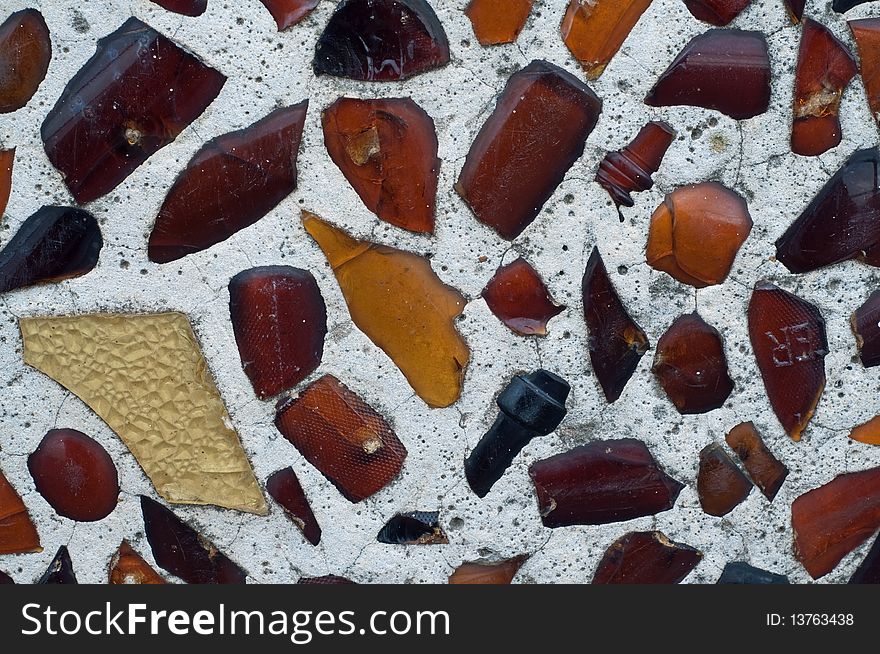 Multicolored glass embedded in artsy wall. Multicolored glass embedded in artsy wall