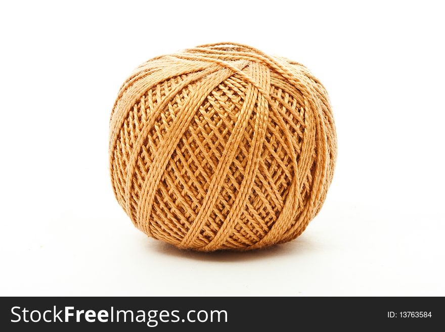 A ball of brown thread isolated on white. A ball of brown thread isolated on white