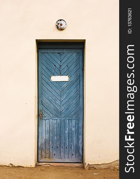 Blue vintage door with empty white doorplate