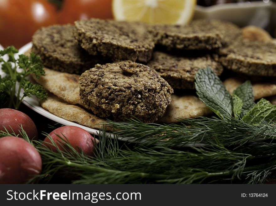 Mediterranean meal of falafels with humus, olives, chickpeas, radishes and tomatoes. Mediterranean meal of falafels with humus, olives, chickpeas, radishes and tomatoes.