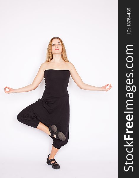 Young blonde woman doing yoga exercise, white background. Young blonde woman doing yoga exercise, white background