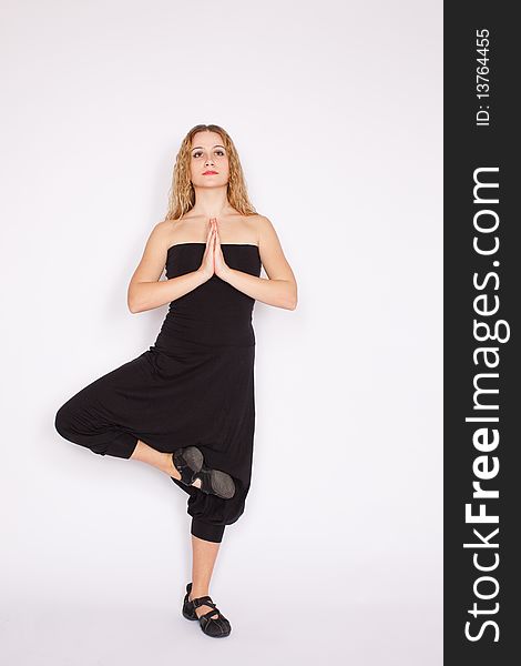 Young blonde woman doing yoga exercise, white background. Young blonde woman doing yoga exercise, white background