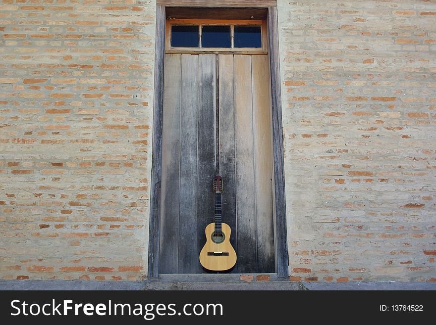 The Guitar on the center of image, in front of the door. The Guitar on the center of image, in front of the door.