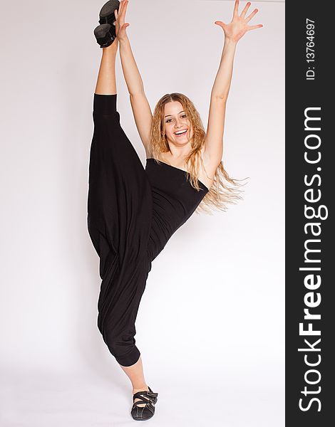 Young blonde woman doing gymnastics, white background. Young blonde woman doing gymnastics, white background