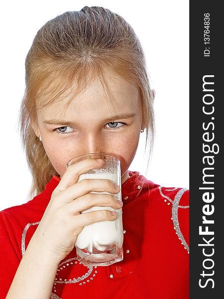 Little girl drinks milk from glass