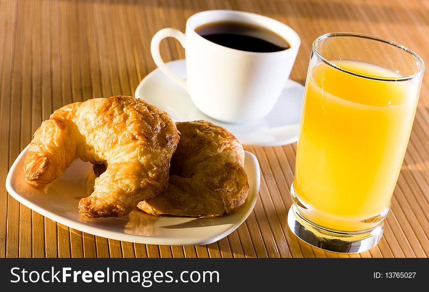 Breakfast with juice and croissants