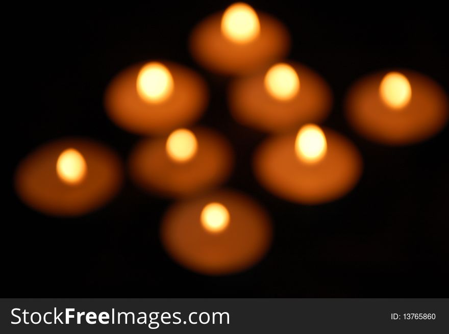 Group of blurry lights from candles