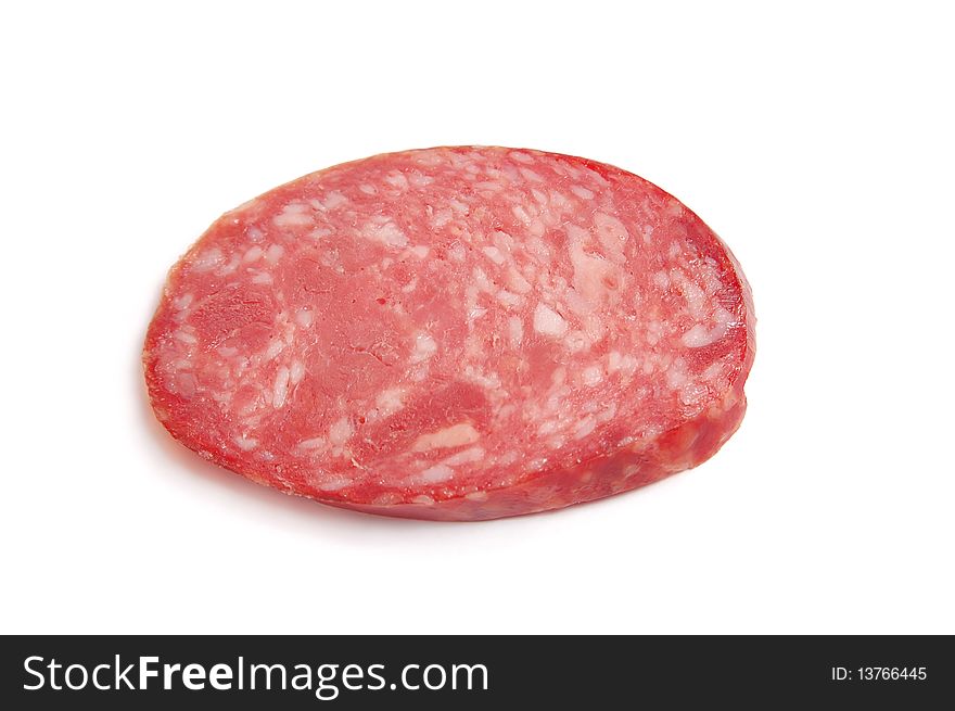 Piece of sausage on the white.